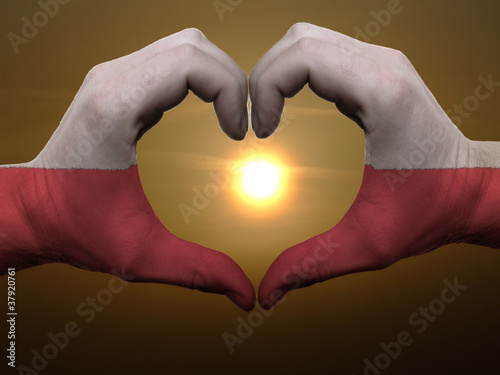 Heart and love gesture by hands colored in poland flag during be