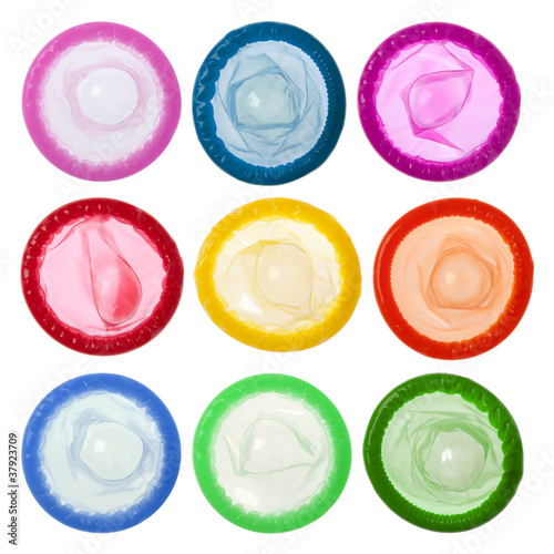 Colorful condoms isolated on white background photo