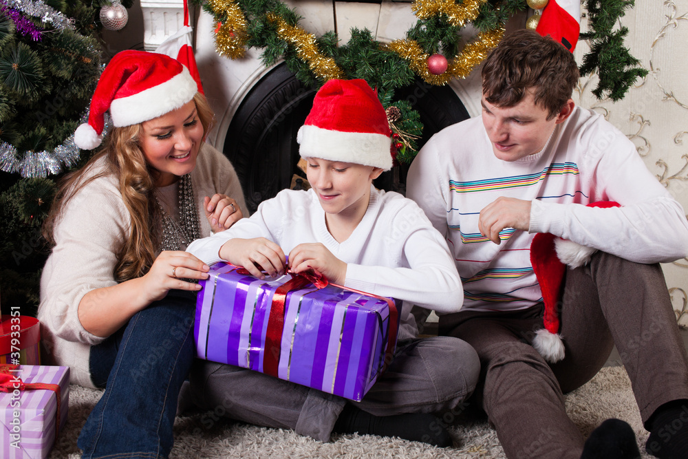 Happy family with Christmas gifts. Happy family with Christmas gifts.