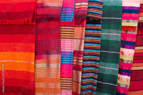 Colorful stripy bed covers on market in Morocco