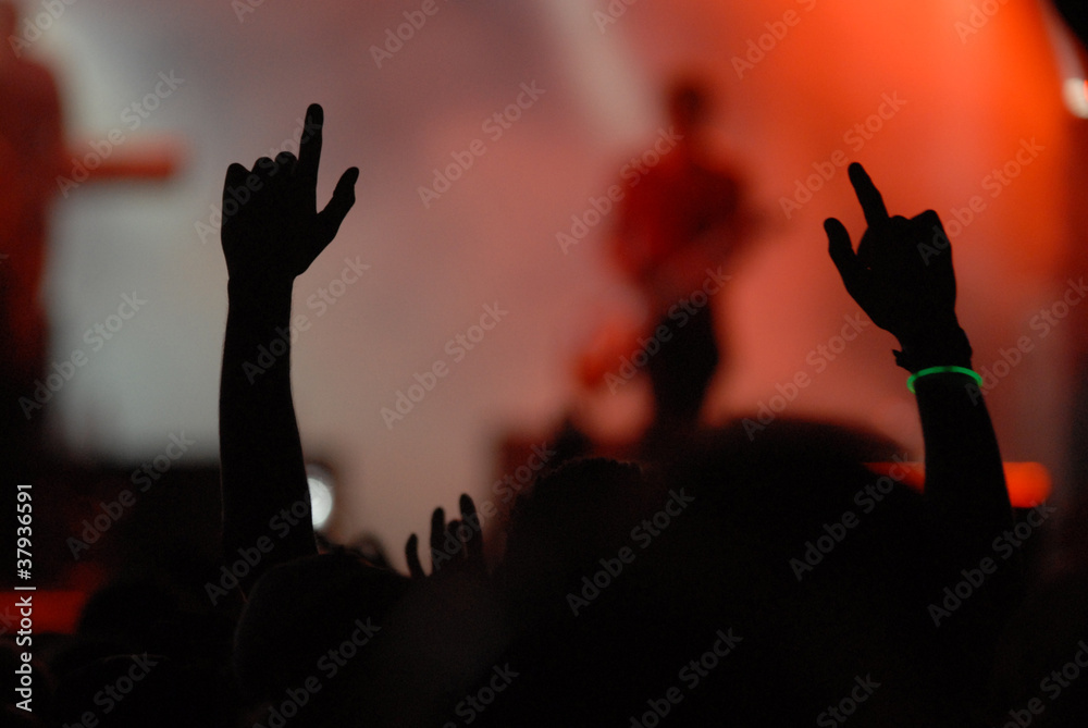 raised hands at rock concert