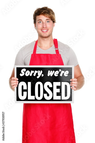 Business shop owner showing closed sign