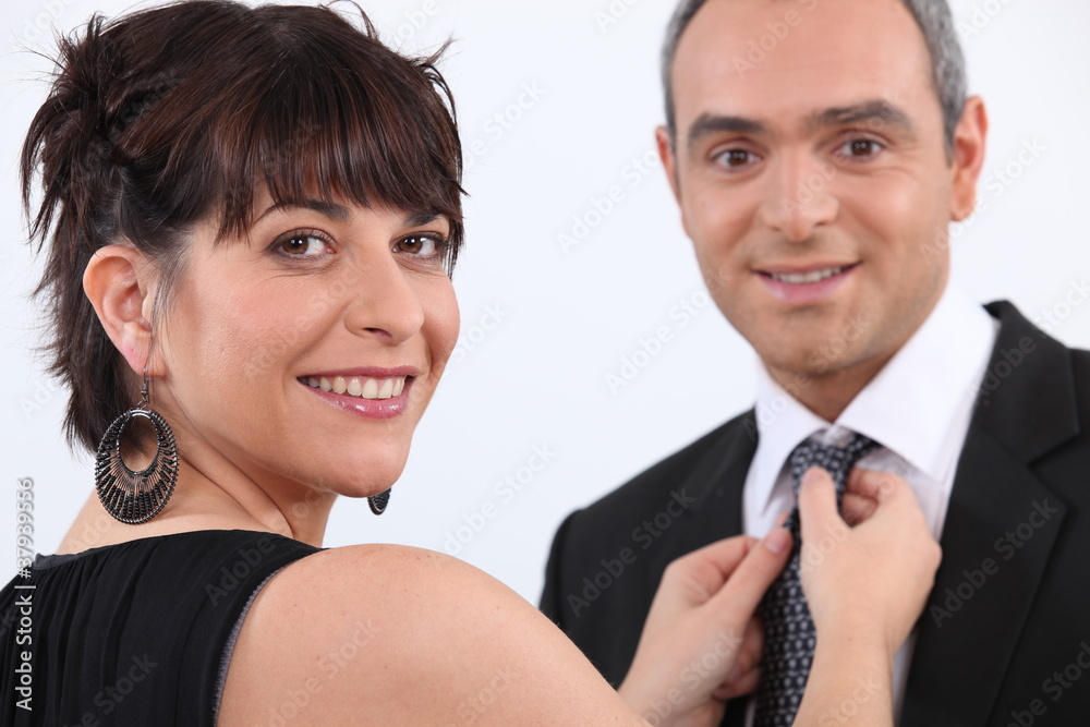 Woman fixing a man's tie