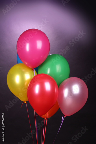 bright balloons on purole background