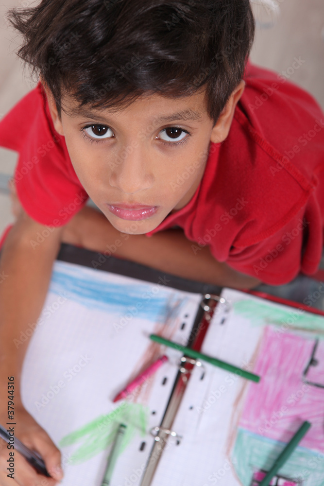 Top-view of bored little boy at school Top-view of bored little boy at school