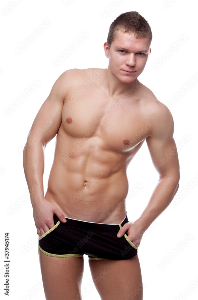 Muscular sexy naked man posing in the studio