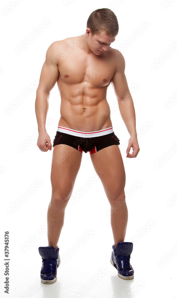 Muscular sexy naked man posing in the studio in underwear