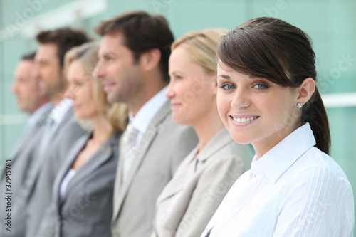 Line up of employees with the youngest in focus