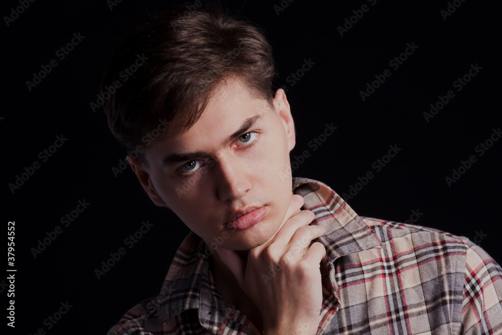 Portrait of a handsome young man in a plaid shirt Portrait of a handsome young man in a plaid shirt