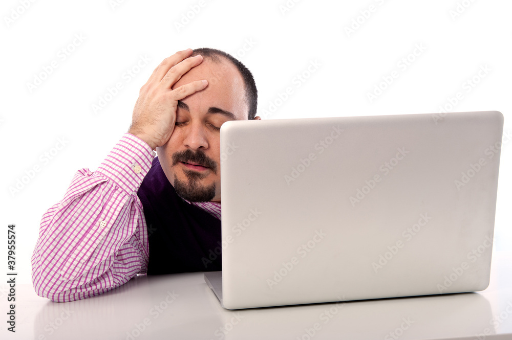 Portrait of a desperate young man looking at laptop Portrait of a desperate young man looking at laptop