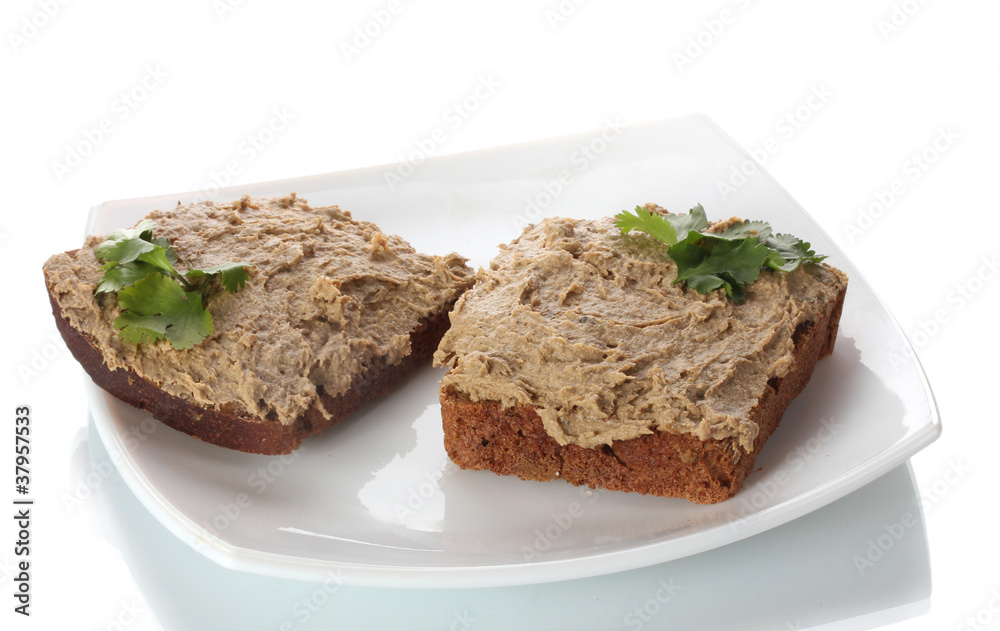 Fresh pate on bread on white plate isolated on white Fresh pate on bread on white plate isolated on white