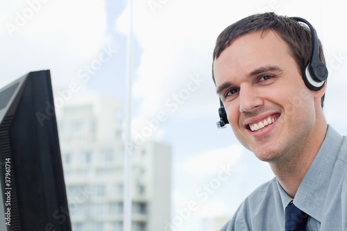 Happy office worker using a headset