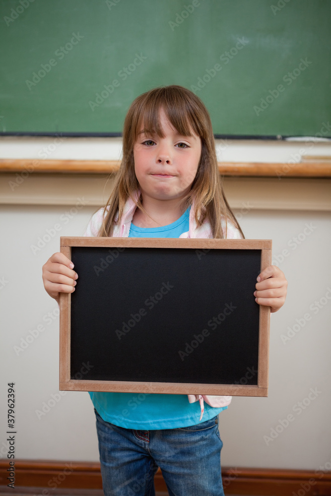 Portrait of a little girl holding a school slate Portrait of a little girl holding a school slate