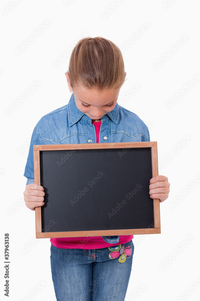 Portrait of a young girl looking at a school slate Portrait of a young girl looking at a school slate