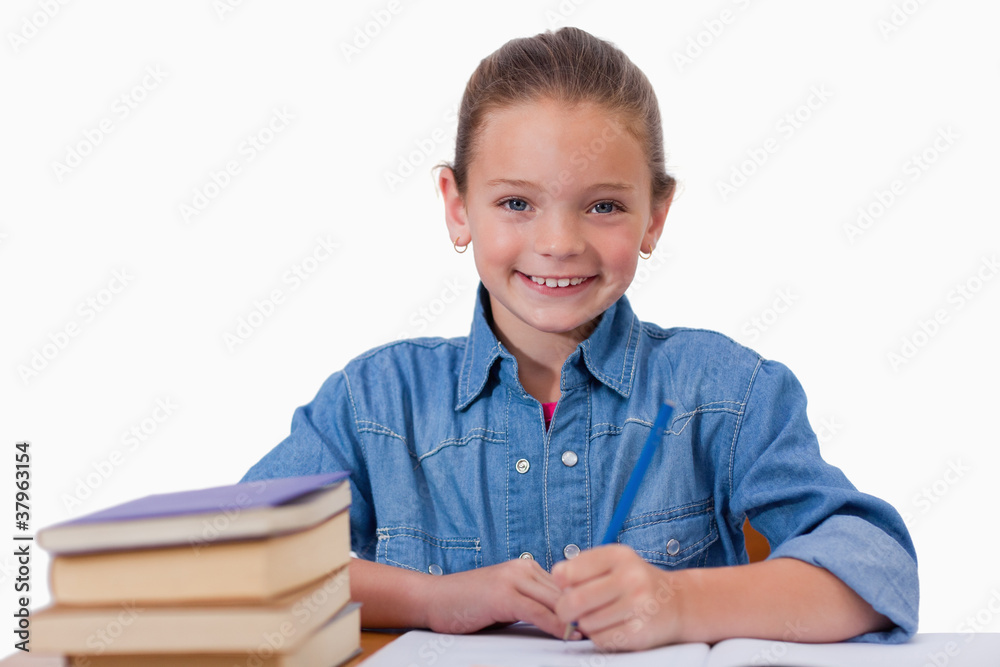 Smiling girl writing on a notebook Smiling girl writing on a notebook