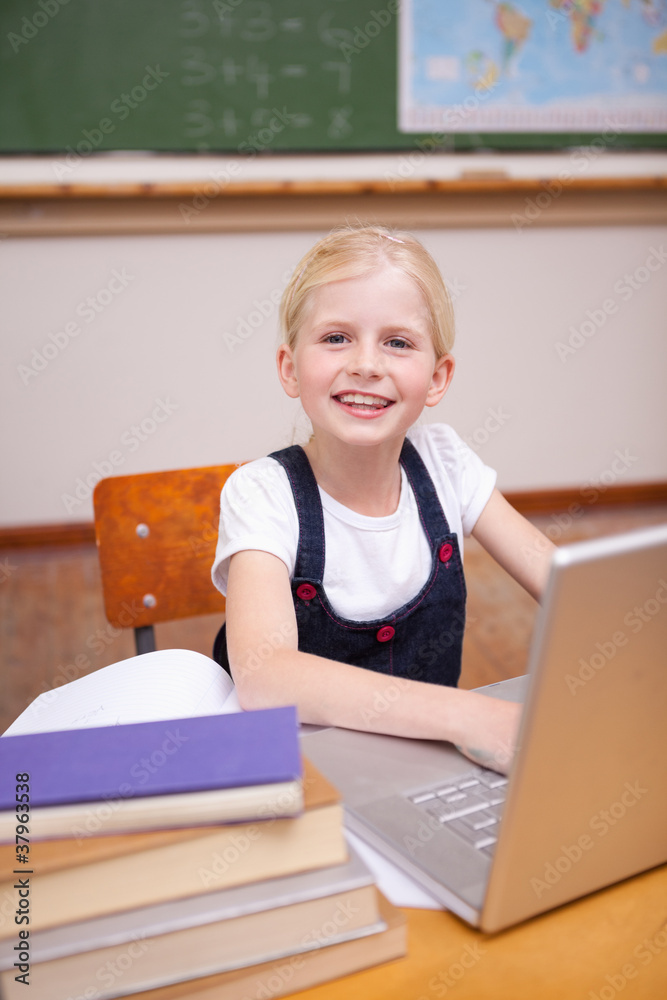 Portrait of a little girl using a notebook Portrait of a little girl using a notebook