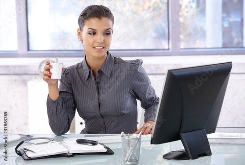 Young businesswoman sitting at desk