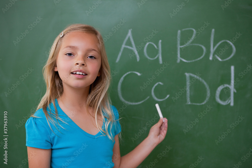 Smiling schoolgirl showing letters Smiling schoolgirl showing letters