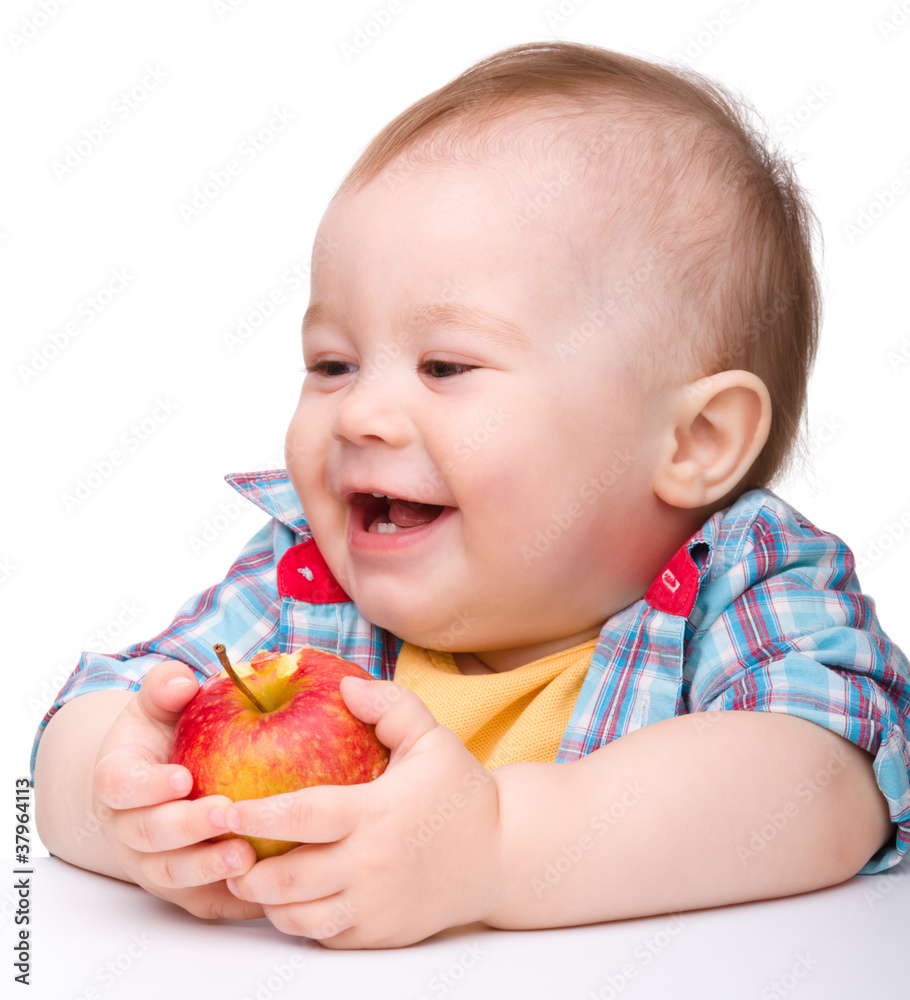 Little child is eating red apple and smile Little child is eating red apple and smile