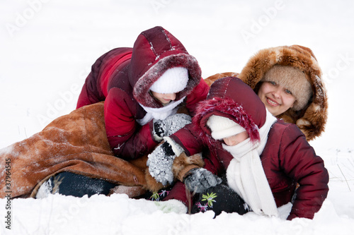 Family cheerfully play to snow