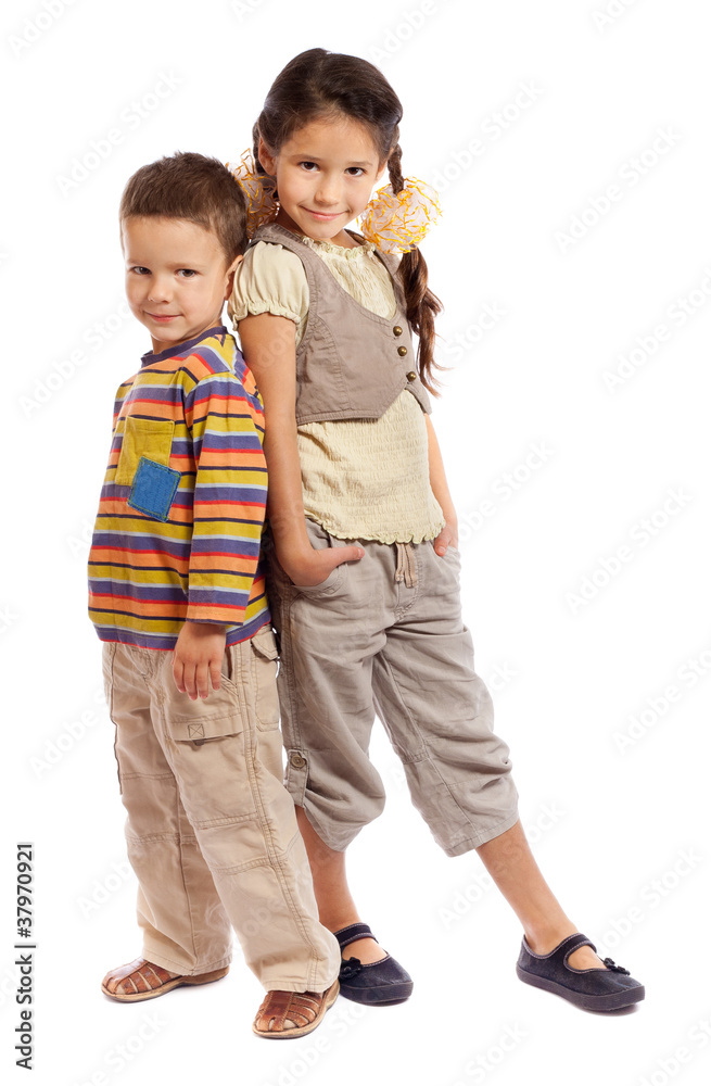 Two smiling little children standing together Two smiling little children standing together