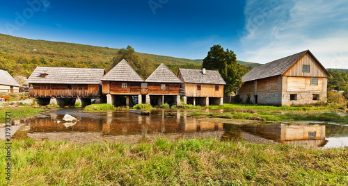 Rural landscape - wooden mill houses in Sinac, Croatia