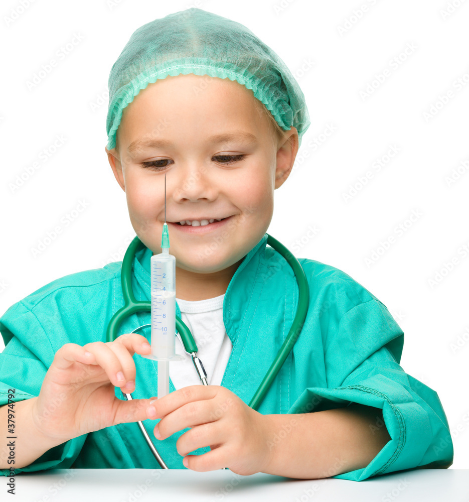 Little girl is playing doctor with syringe