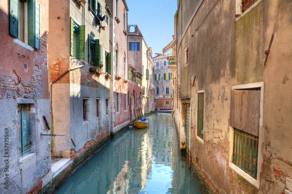 Small canal among houses. Venice, Italy.