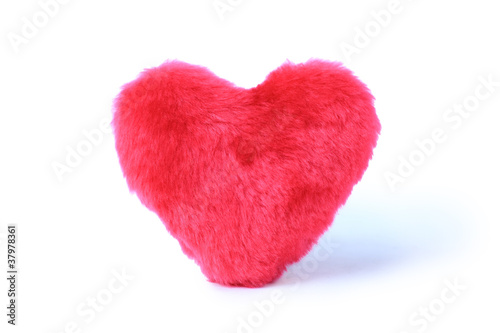 Soft pink heart pillow on white background