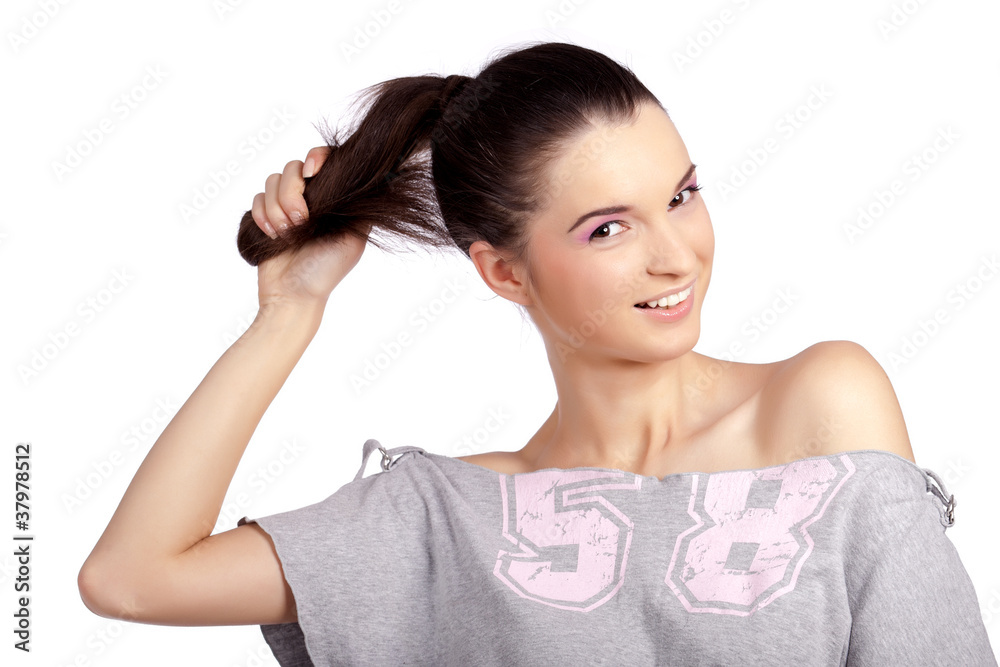 Happy young girl pulling her healthy ponytail Happy young girl pulling her healthy ponytail