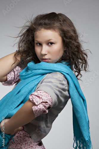 portrait of a beautiful girl with perfect skin and a scarf