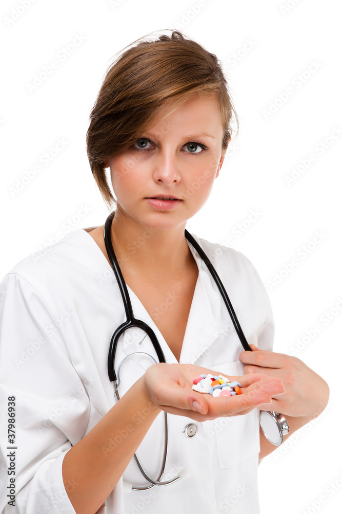 Young female doctor holding pills isolated on white background Young female doctor holding pills isolated on white background