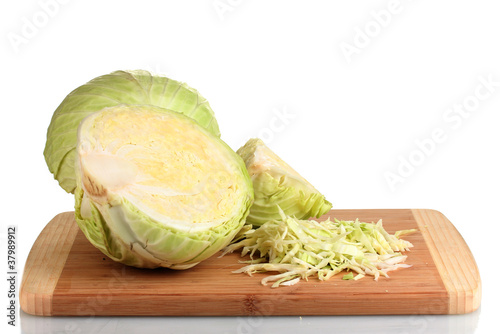 green cabbage shredded on wooden board isolated on white