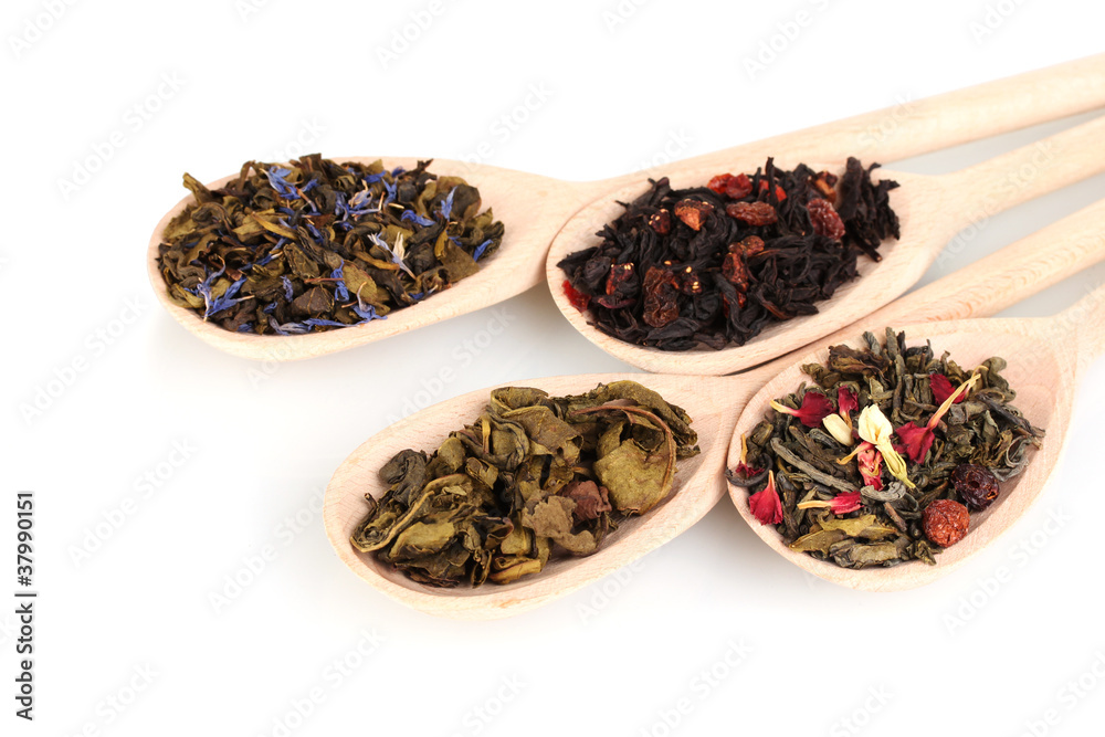 Collection of dry green and black tea in wooden spoons isolated Collection of dry green and black tea in wooden spoons isolated