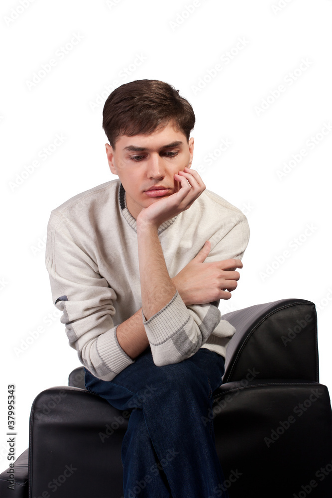 thoughtful young man on the sofa thoughtful young man on the sofa