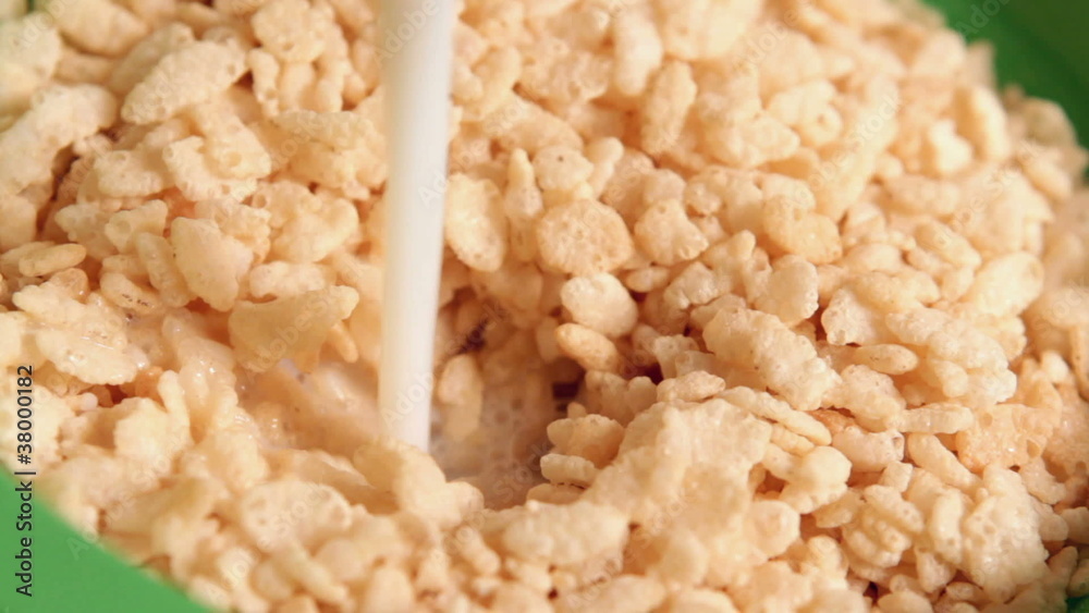 Bowl of Cereal filling with millk Bowl of Cereal filling with millk