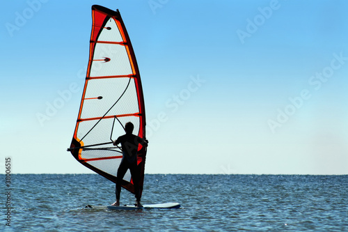 Silhouette of a windsurfer on the sea