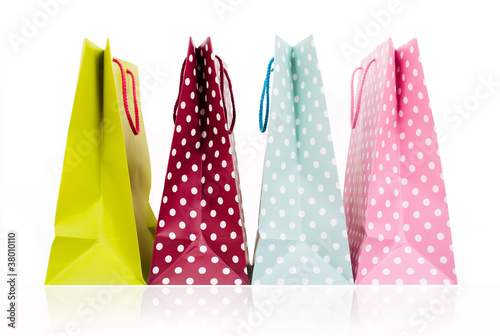Assorted colored shopping bags on white background