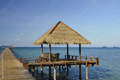 house with reed roof above the sea