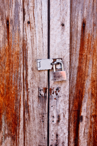 padlock on the old wooden wall