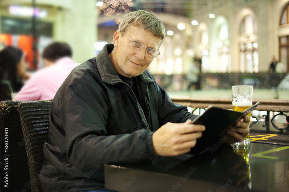Mature man reading menu card