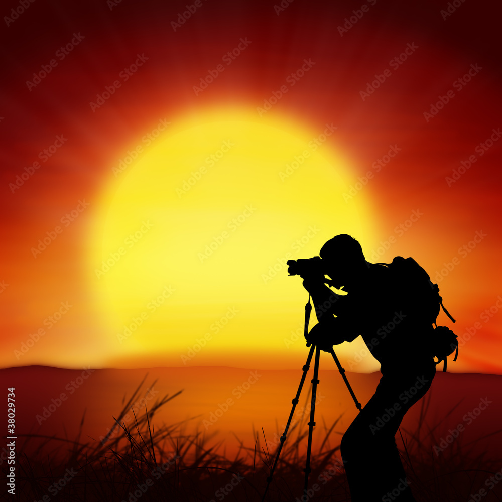 silhouette of photographer with big sun background
