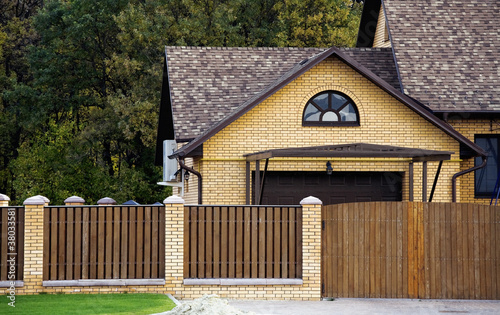 brick house and fence in an...
