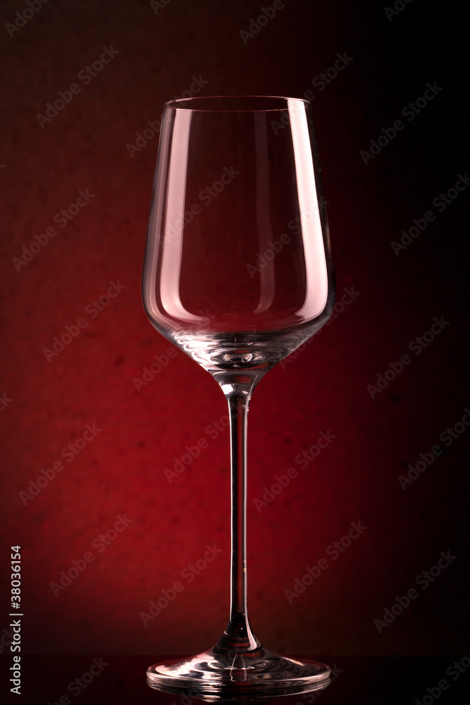 empty wineglass on red background