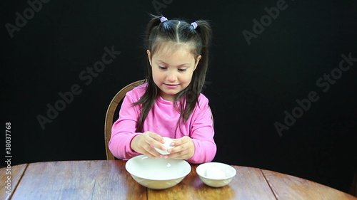 Child cracking a raw egg photo