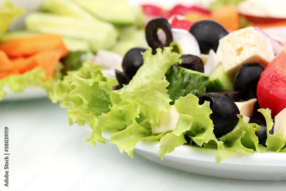 Greek salad on plate and sliced ​​vegetables closeup Greek salad on plate and sliced ​​vegetables closeup