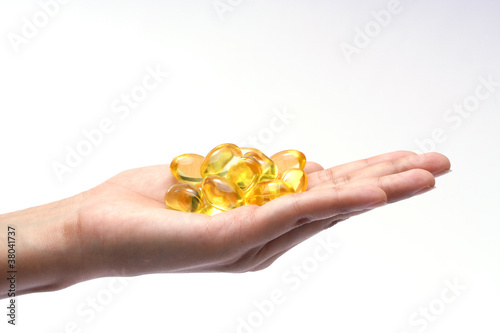 Cod liver oil pills in the hand