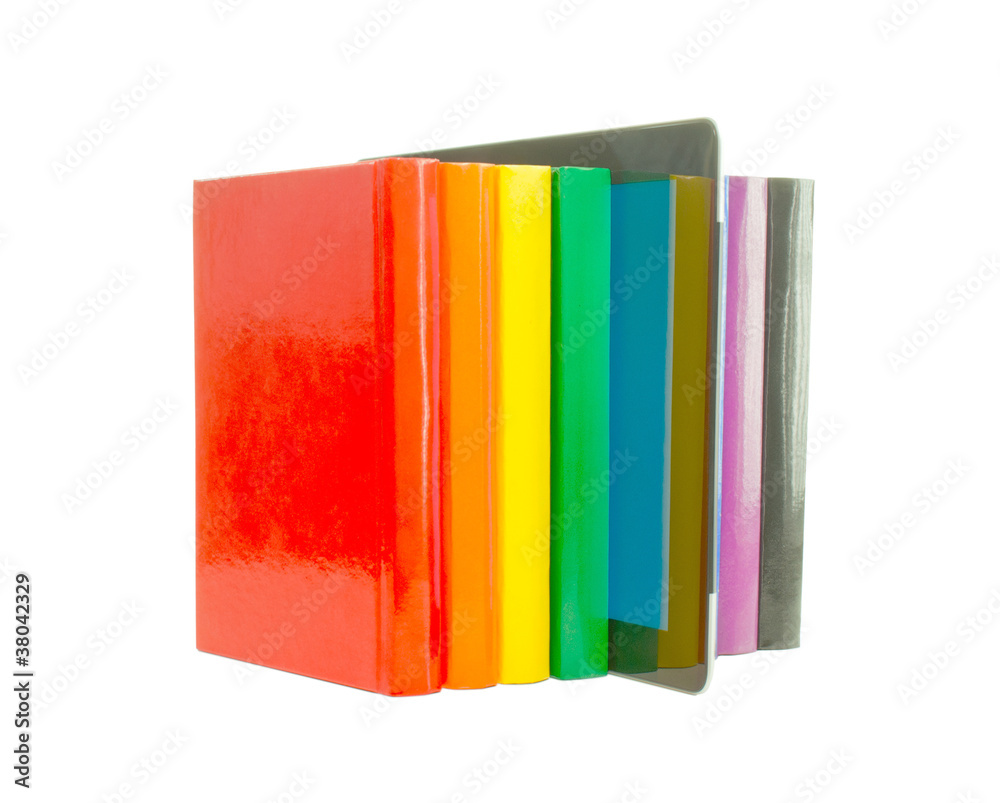 Row of colorful books and electronic book reader over white back Row of colorful books and electronic book reader over white back