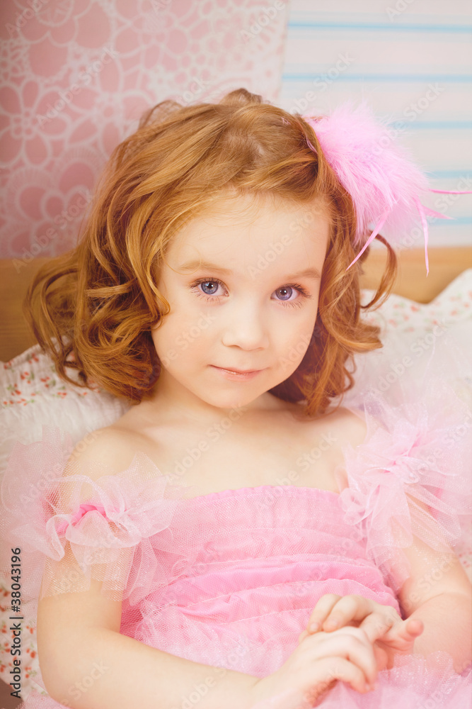 Girl in the nursery in pink dresses