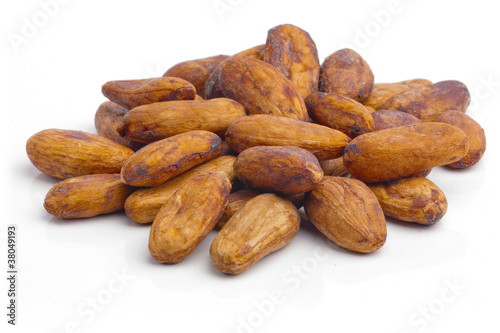 Raw cacao beans isolated on white background.